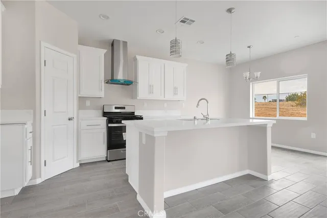 a kitchen with a sink and a stove top oven