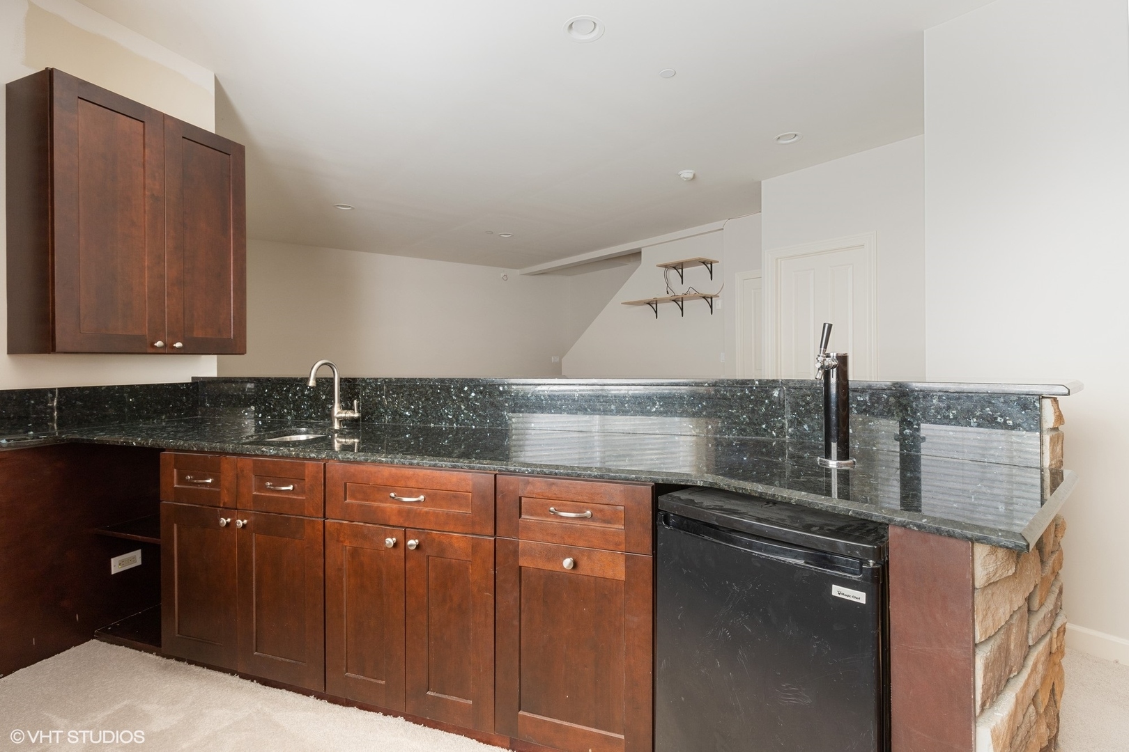 21 Northfield Terrace, Unit 21 Wheeling, IL 60090 - Photo 16 of 18 a kitchen with granite countertop a sink and cabinets
