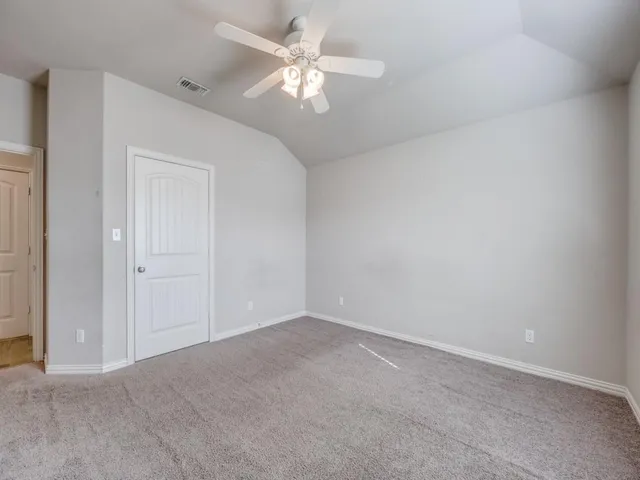 a view of a big room with chandelier fan