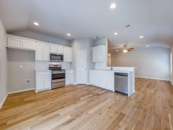 a large kitchen with kitchen island a sink dishwasher stove and refrigerator