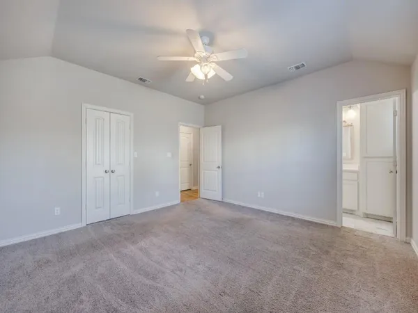 a view of an empty room with a ceiling fan