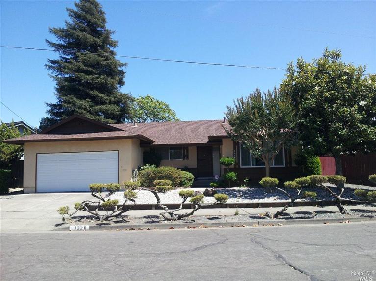 1328 Phyllis Street Santa Rosa, CA 95401 - Photo 1 of 1 a row of table and chairs in front of house