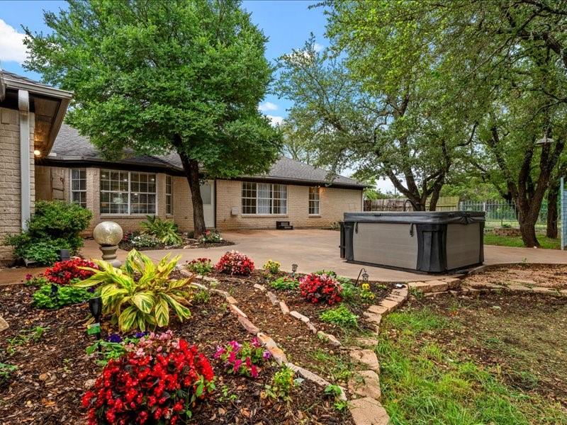1072 Chapman Road Crawford, TX 76638 - Photo 29 of 39 a front view of a house with flower garden