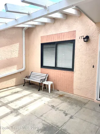 a backyard of a house with table and chairs