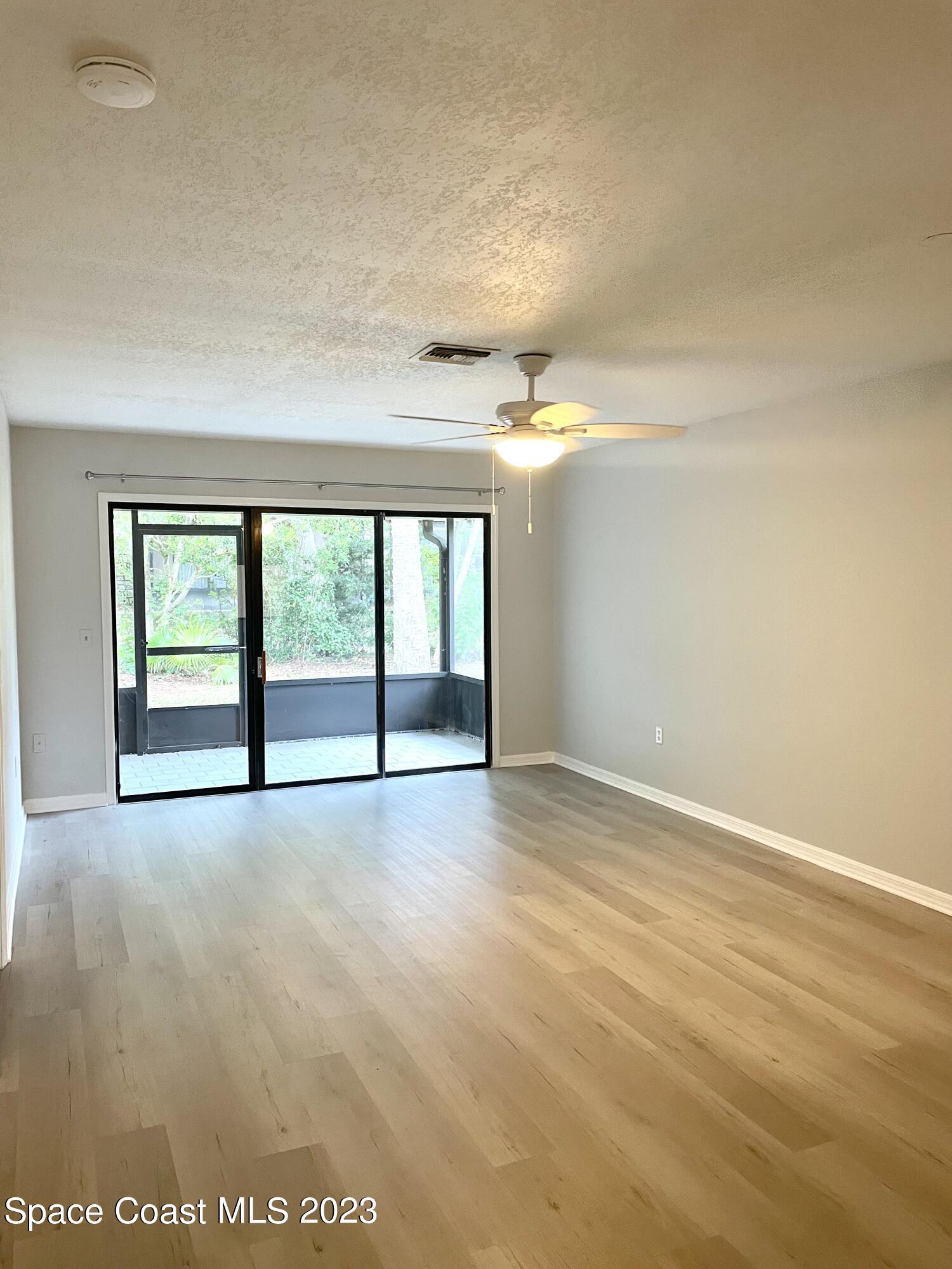 179 Shell Place, Unit 36 Rockledge, FL 32955 - Photo 5 of 20 an empty room with windows and city view