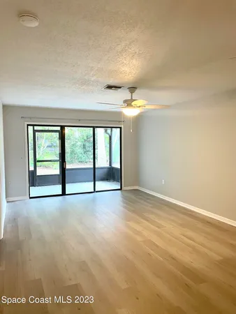 an empty room with windows and city view