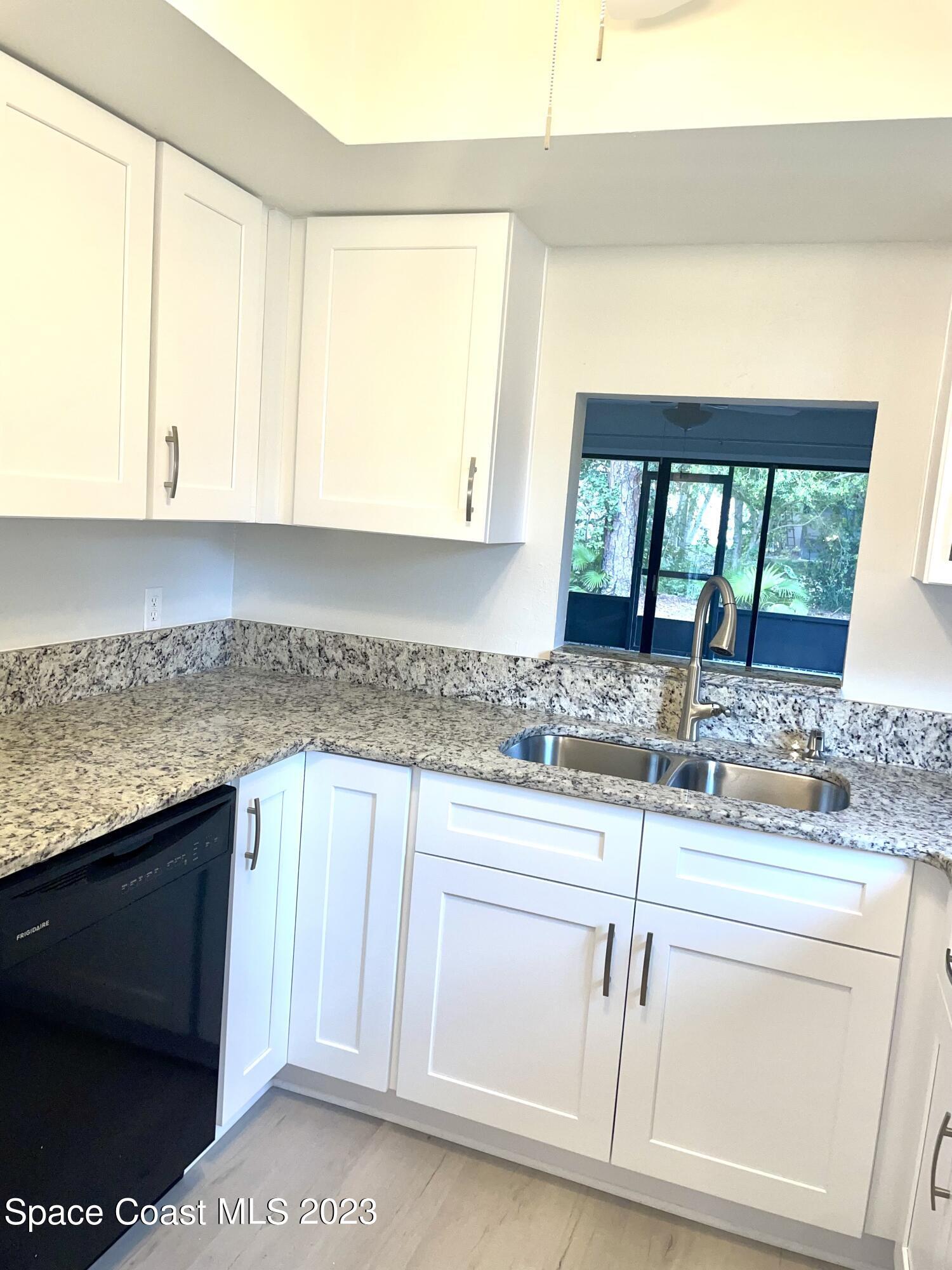 179 Shell Place, Unit 36 Rockledge, FL 32955 - Photo 10 of 20 a kitchen with granite countertop a sink and cabinets