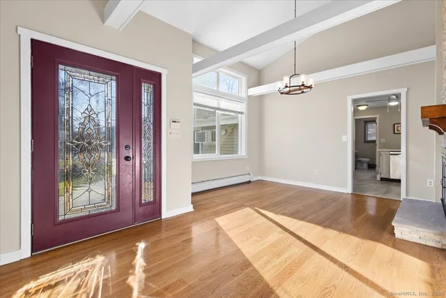 a view of a livingroom with a balcony furniture and wooden floor