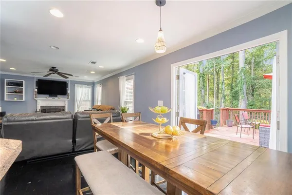 a kitchen with a stove a kitchen island a stove and a living room view