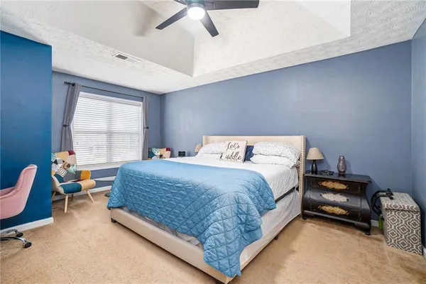 a bedroom with a bed chair and window