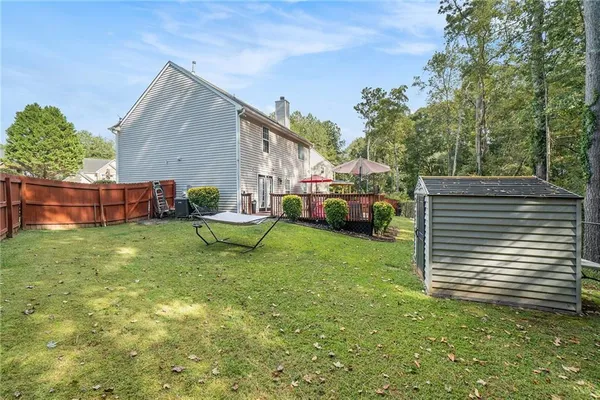 a view of a backyard with couches chairs and a yard