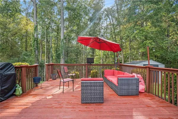 an outdoor sitting area with furniture and wooden deck