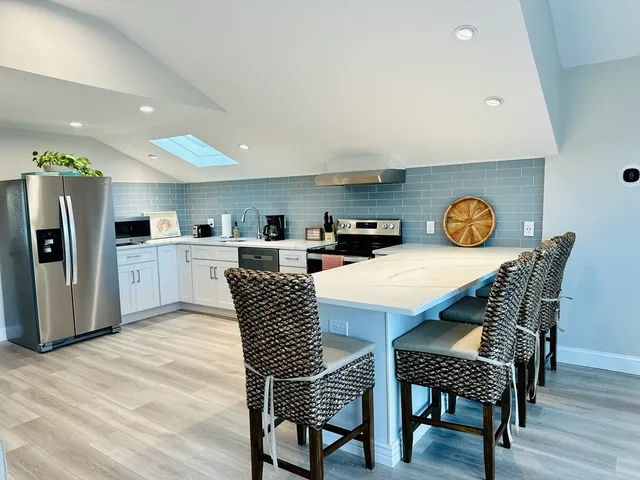a dining room with furniture and a kitchen view