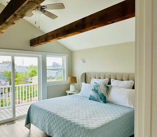 a bedroom with a bed and a large window