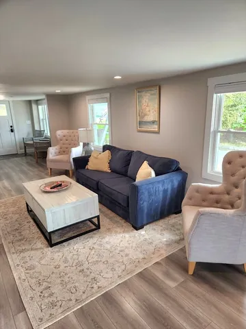 a kitchen with a table chairs refrigerator and window