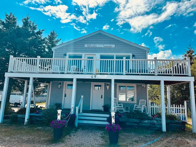 a front view of a house with a deck