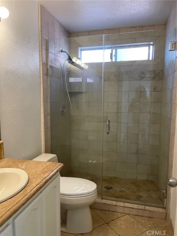 a bathroom with a shower and a toilet