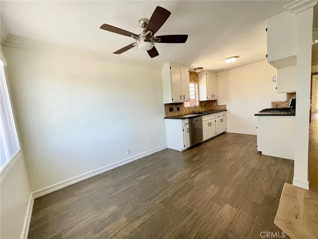 a large kitchen with granite countertop a sink and stainless steel appliances