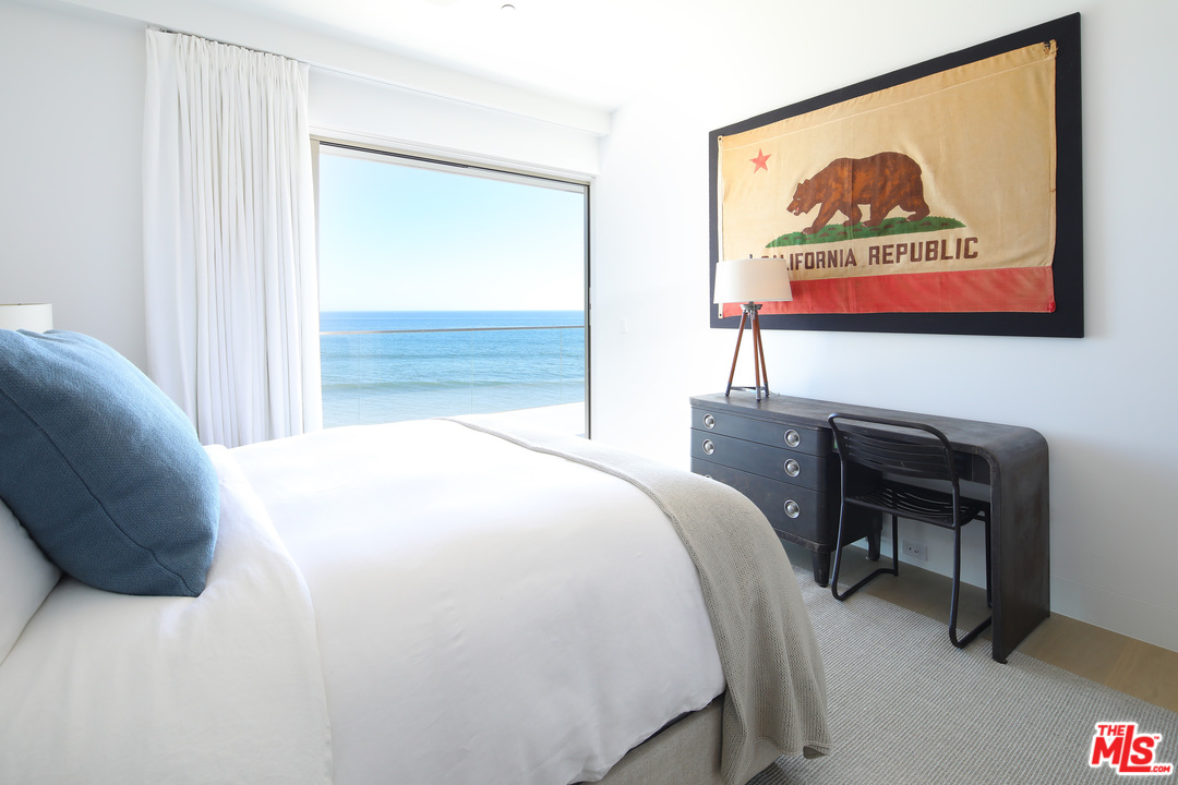 23956 Malibu Road Malibu, CA 90265 - Photo 16 of 26 a bedroom with a bed and a painting on the wall