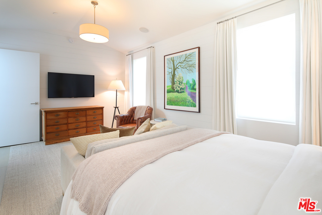 23956 Malibu Road Malibu, CA 90265 - Photo 17 of 26 a bedroom with a bed and a flat screen tv