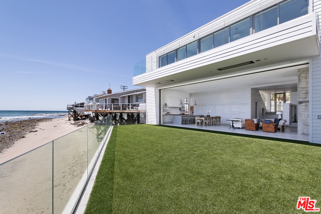 23956 Malibu Road Malibu, CA 90265 - Photo 21 of 26 a view of a house with a swimming pool and sitting area
