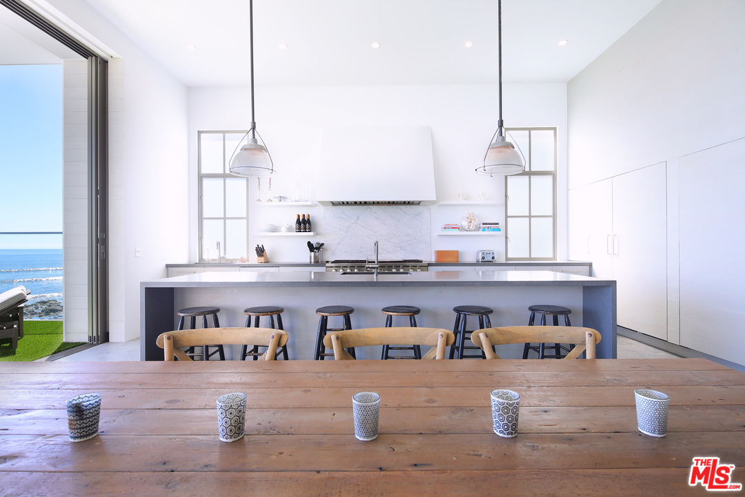 23956 Malibu Road Malibu, CA 90265 - Photo 6 of 26 a kitchen with stainless steel appliances granite countertop a stove a sink and a wooden cabinets