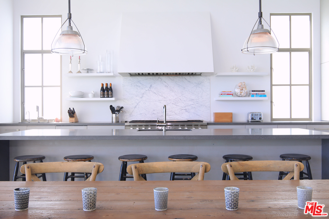 23956 Malibu Road Malibu, CA 90265 - Photo 8 of 26 a kitchen with a window a sink and wooden cabinets
