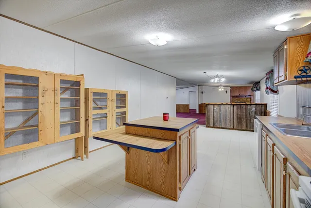 a kitchen with stainless steel appliances granite countertop a sink and a refrigerator