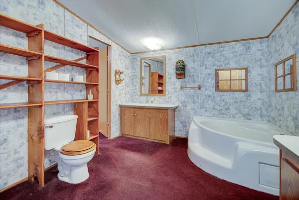 a bathroom with a toilet sink and mirror