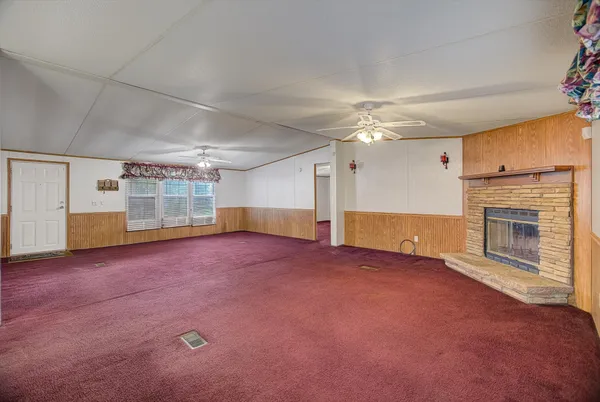 a view of an empty room with a fireplace