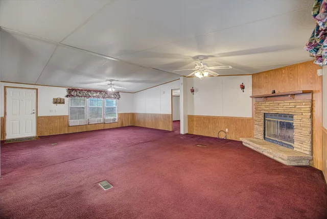 a view of an empty room with a fireplace