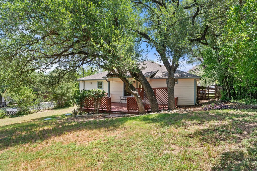 5208 Sioux Lane Austin, TX 78734 - Photo 2 of 35 A private, fenced backyard offers a serene retreat with a wood deck for outdoor enjoyment.