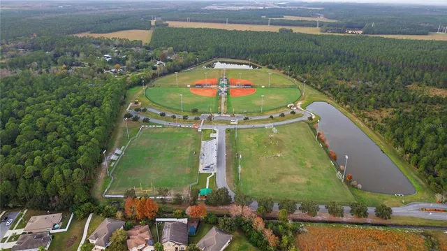 an aerial view of a residential apartment building with a yard