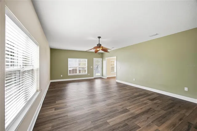 a view of a livingroom with wooden floor and a window