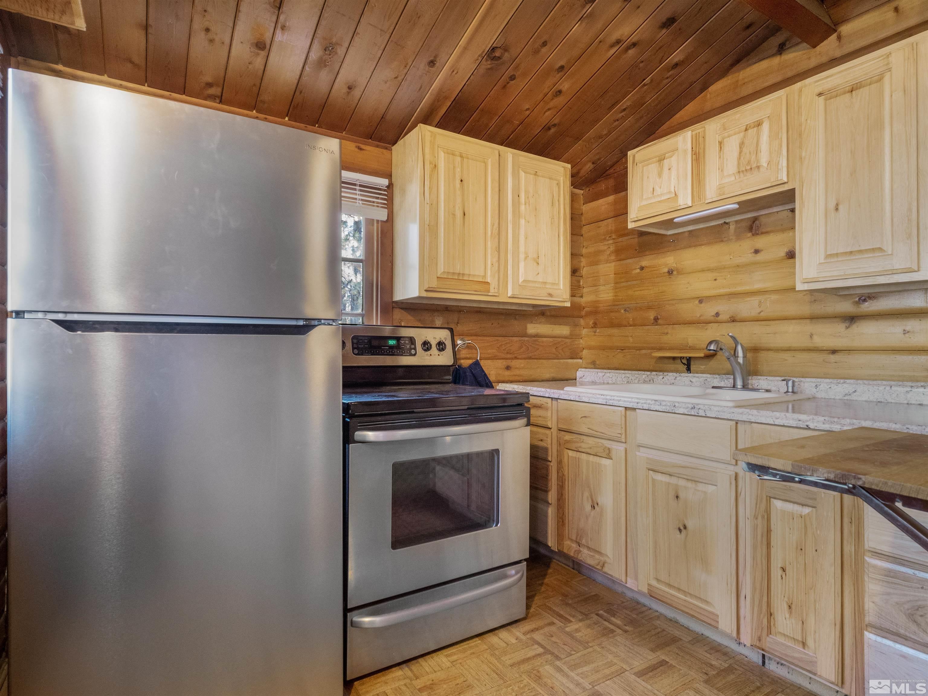 77 Ox Bow Markleeville, CA 96120 - Photo 14 of 33 a kitchen with stainless steel appliances a refrigerator sink and cabinets