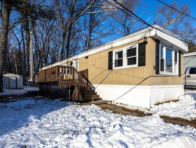 a view of a house with snow on the background