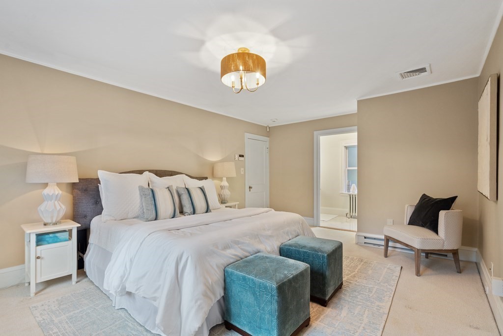 7 Stanley Road Newton, MA 02468 - Photo 11 of 18 a bedroom with a bed and a chandelier