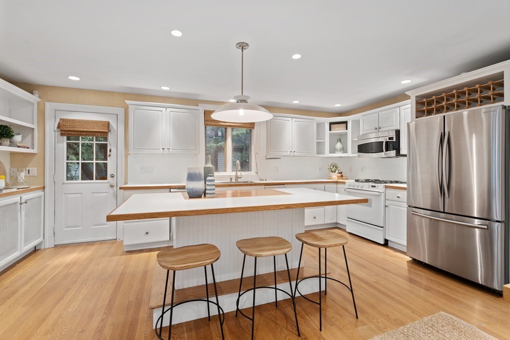 7 Stanley Road Newton, MA 02468 - Photo 7 of 18 a kitchen with stainless steel appliances granite countertop a sink a stove a refrigerator and island with wooden floor