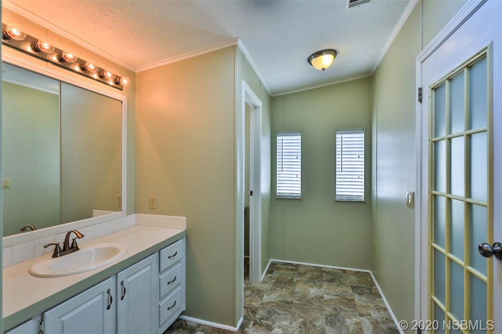 757 Navigators Way Edgewater, FL 32141 - Photo 22 of 41 a bathroom with a double vanity sink and a mirror