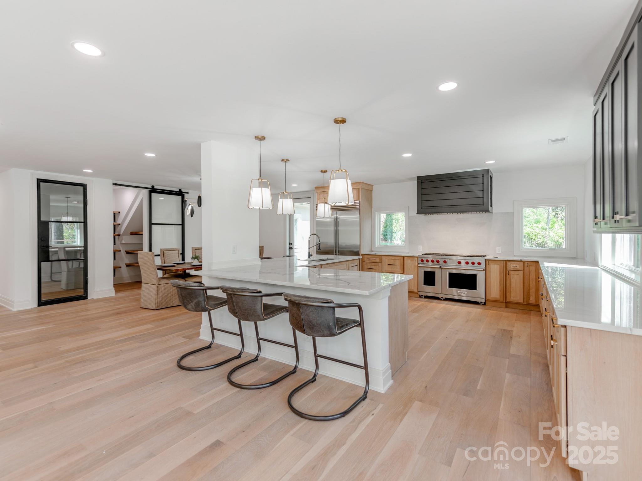 1417 South Wendover Road Charlotte, NC 28211 - Photo 11 of 44 a living room with furniture a flat screen tv and kitchen view