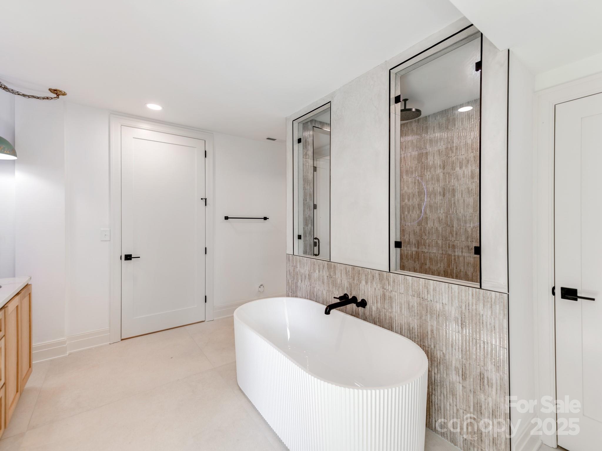 1417 South Wendover Road Charlotte, NC 28211 - Photo 24 of 44 a bathroom with a bathtub and shower