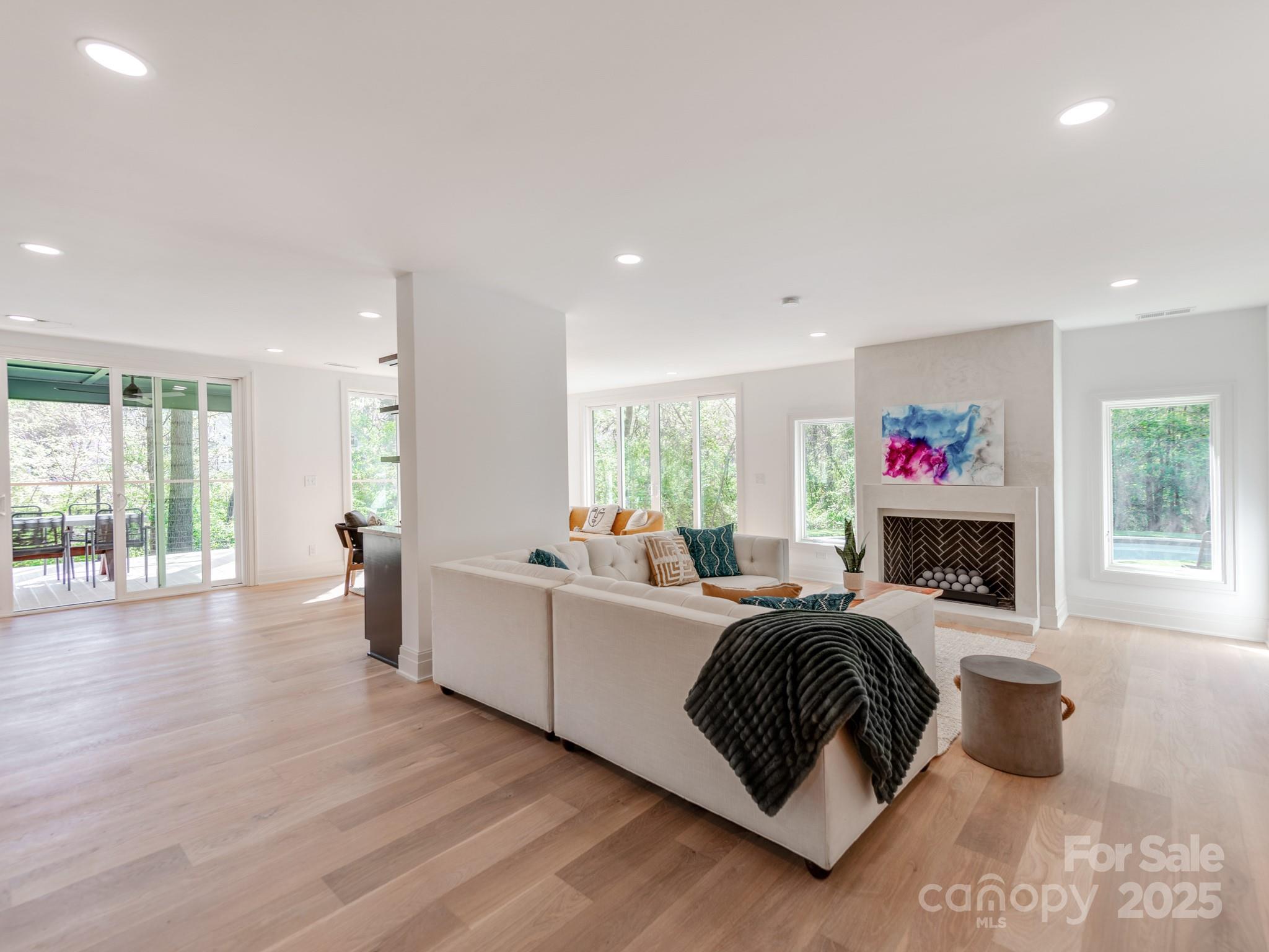 1417 South Wendover Road Charlotte, NC 28211 - Photo 5 of 44 a living room with furniture a flat screen tv and a large window