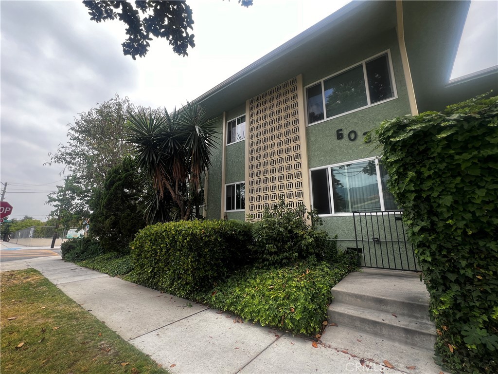 a front view of a house with garden