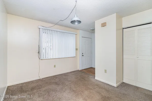 a view of an empty room with windows