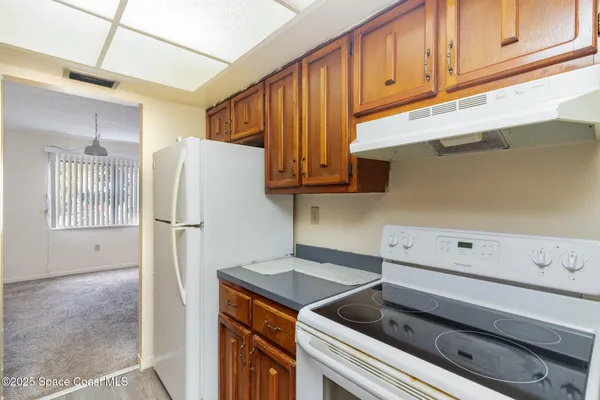 a kitchen with a refrigerator and cabinets