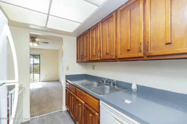 a kitchen with stainless steel appliances granite countertop a sink window and cabinets