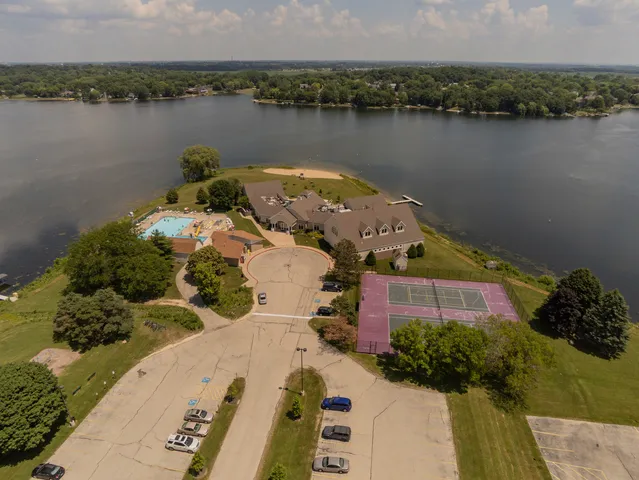 an aerial view of a house with outdoor space and lake view