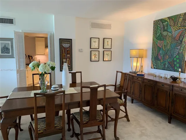 a view of a dining room with furniture and window