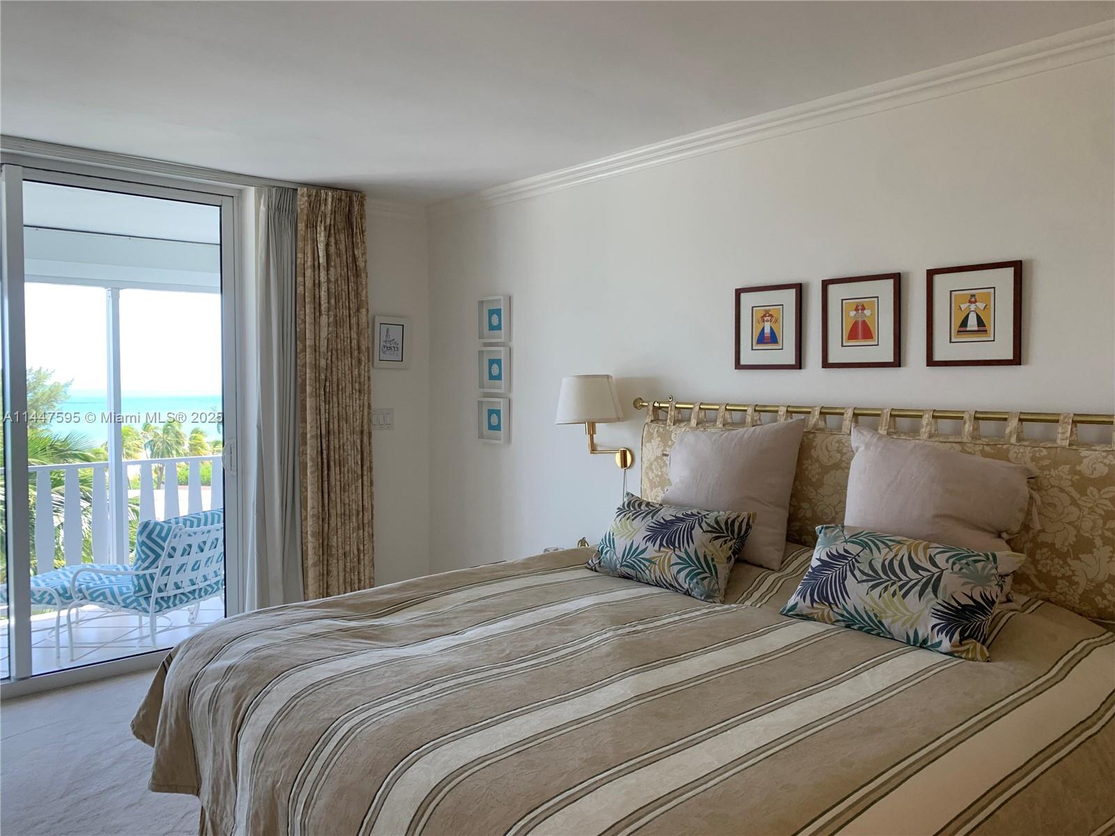 200 Ocean Ln Drive, Unit 706 Key Biscayne, FL 33149 - Photo 13 of 28 a bedroom with a bed and wooden floor