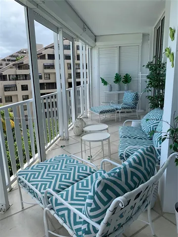 a view of a patio with couches table and chairs and potted plants